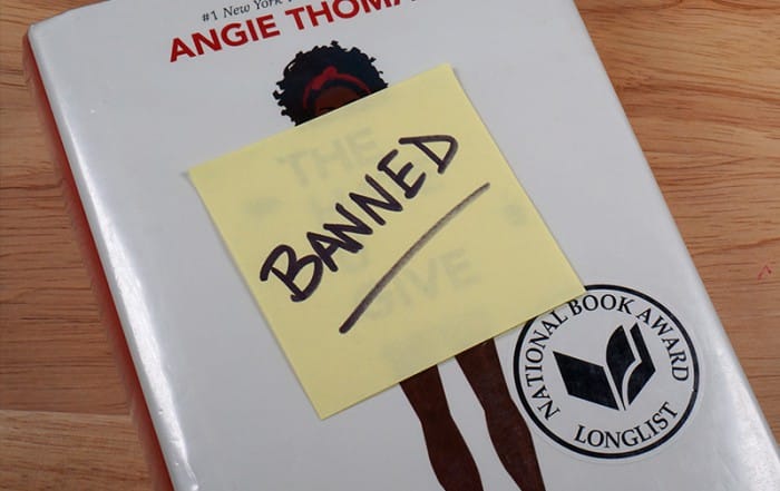 The Hate You Give Book with a post-it note that says "Banned" on it on the cover