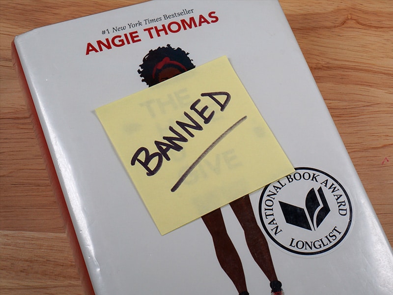 The Hate You Give Book with a post-it note that says "Banned" on it on the cover